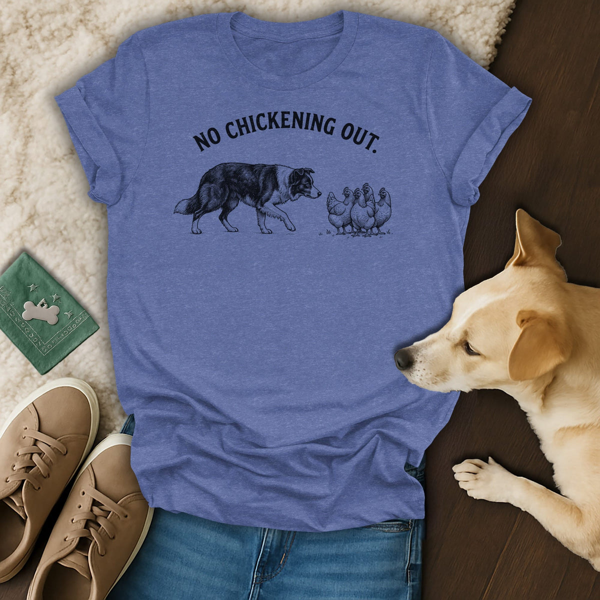 Blue t-shirt with black print of a dog facing chickens and text "NO CHICKENING OUT."