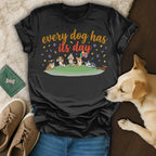 T-shirt with cartoon dogs and "Every dog has its day" text.
