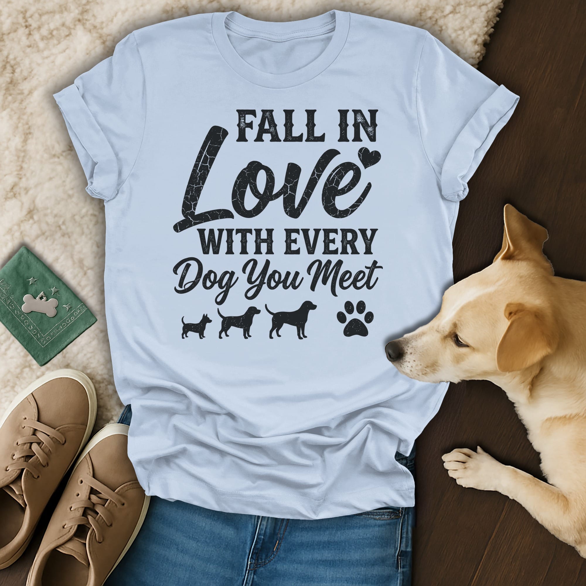 Light blue t-shirt with "Fall in Love With Every Dog You Meet" text and dog silhouettes.