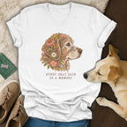 A white V-neck t-shirt featuring a golden retriever floral illustration with the text Every gray hair is a memory.