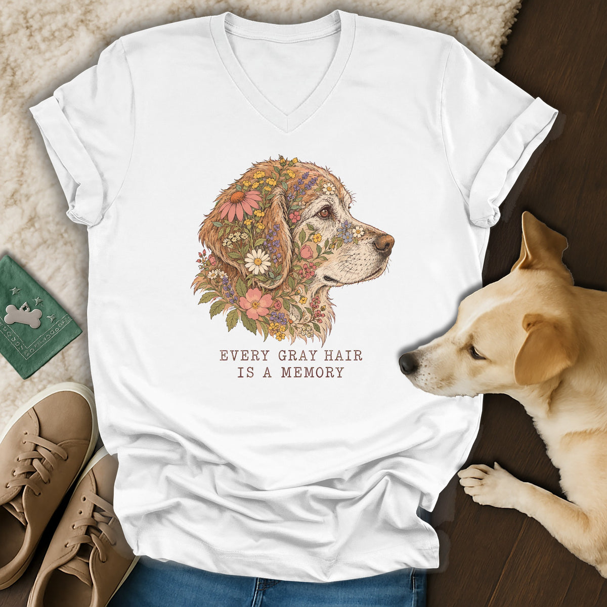 A white V-neck t-shirt featuring a golden retriever floral illustration with the text Every gray hair is a memory.