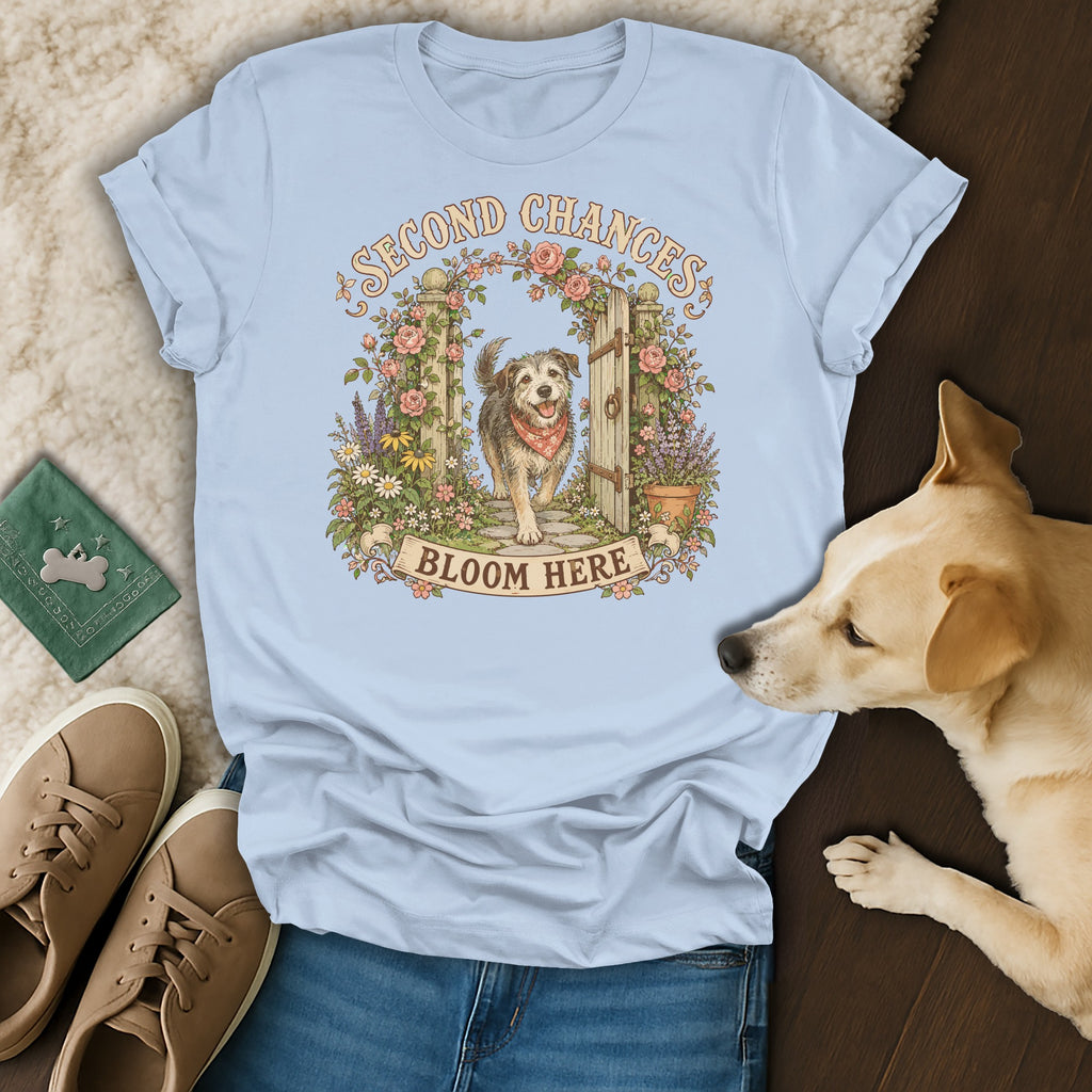 Light blue t-shirt featuring a dog graphic, surrounded by sneakers and a sleeping dog.