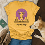 Yellow t-shirt with "Paws Up" text, two speakers, and a dog silhouette.