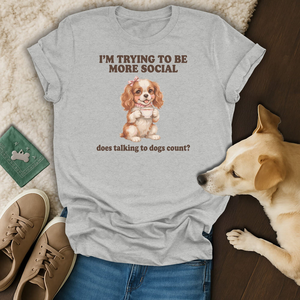 Light grey t-shirt with "I'M TRYING TO BE MORE SOCIAL" and a dog holding coffee.
