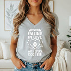 Grey v-neck t-shirt with white text and paw print graphic: "Can't Help Falling In Love With Every Dog I See"