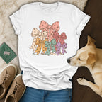 A white t-shirt featuring a stack of colorful bows patterned with small paw prints.