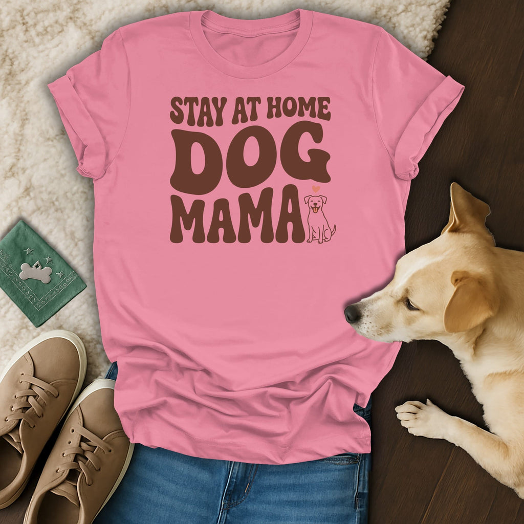 Pink t-shirt with brown text "STAY AT HOME DOG MAMA" and a small dog graphic.