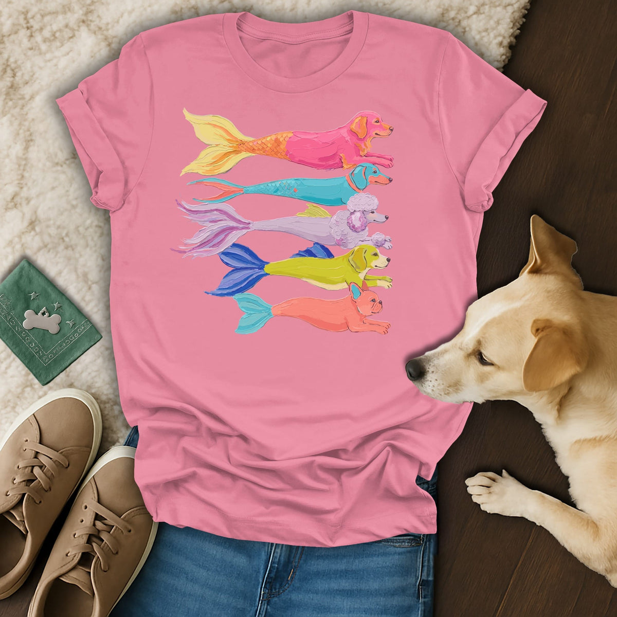 Pink t-shirt with a row of colorful mermaid dogs and a golden retriever.