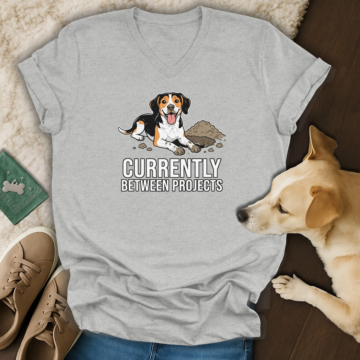Grey t-shirt with cartoon dog and text "Currently Between Projects".