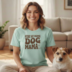 Woman wearing light blue t-shirt with "Stay at Home Dog Mama" text and small dog graphic.
