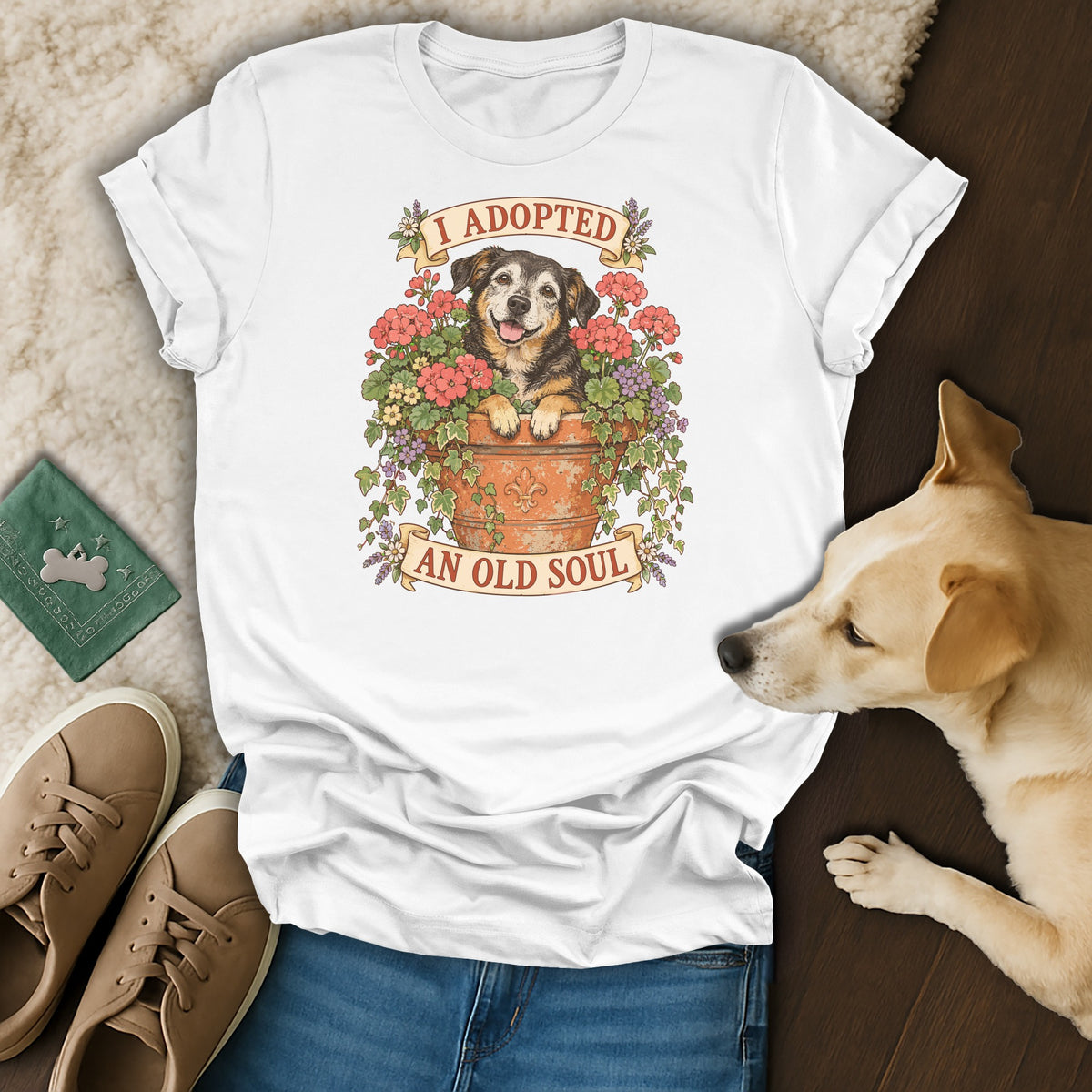 A white t-shirt featuring a graphic of a dog in a flower pot with the text I adopted an old soul.