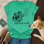 T-shirt with three dogs and dandelion with paw print seeds, "Three Snouts, One Wish" text.
