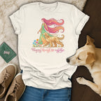 T-shirt with flowing hair woman and dog walking through flowers.