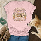 Light pink t-shirt featuring a graphic of four dogs on a bench, with text reading MIMIS GRANDDOGS.