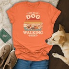 Orange t-shirt with dogs walking graphic and text "This is my dog walking shirt".