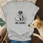 Grey t-shirt with a black and white drawing of a dog and text "NO SAINT."