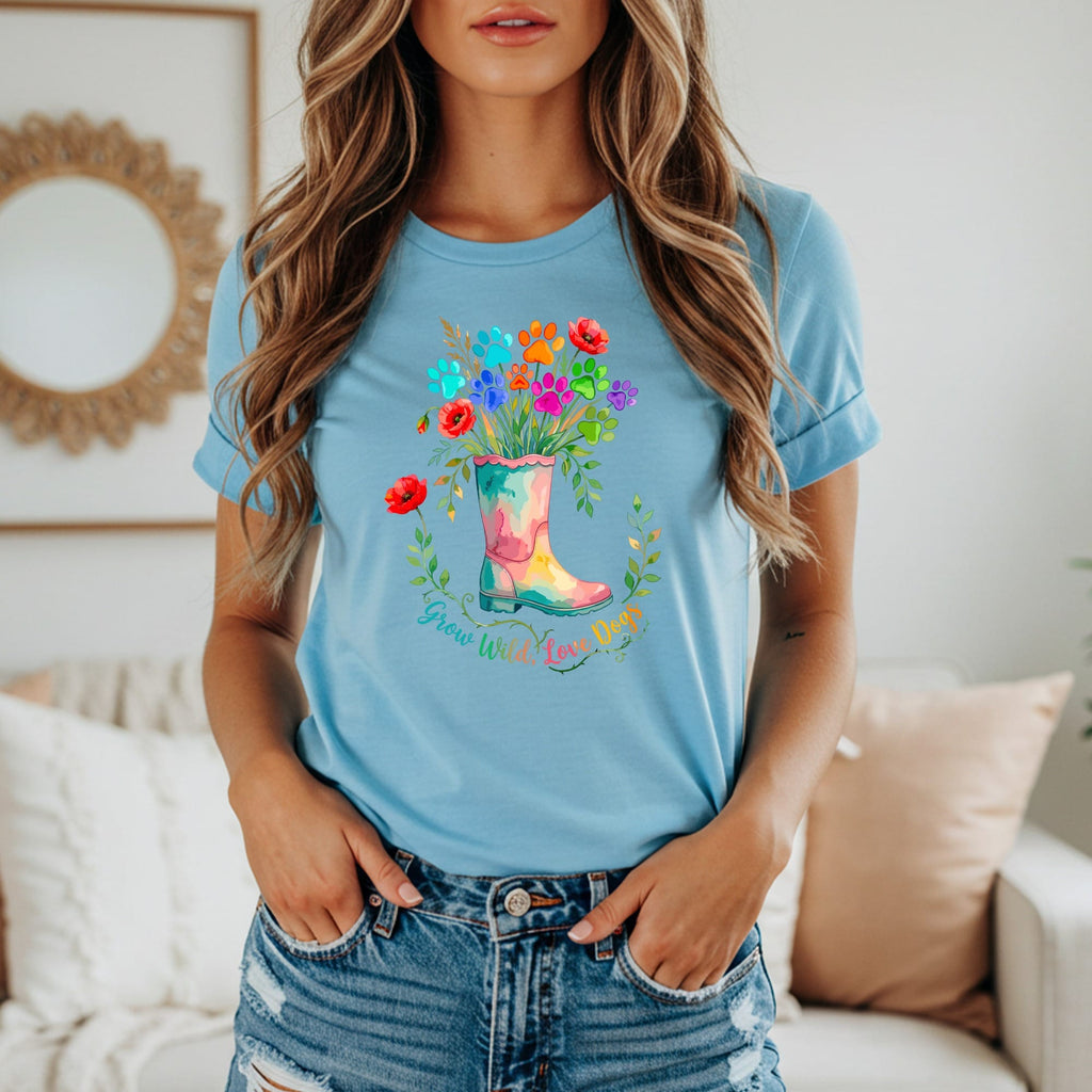 Light blue t-shirt with colorful paw prints and flowers in a boot graphic that reads "Grow Wild, Love Dogs."
