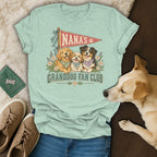 Light green t-shirt with a Nana's Granddog Fan Club graphic featuring three dogs, surrounded by shoes and a real dog.