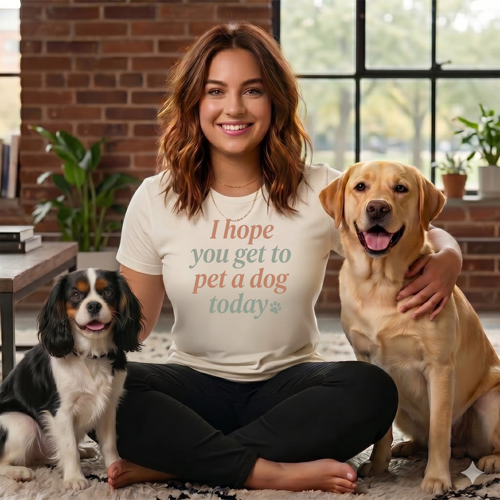Woman wearing t-shirt with text "I hope you get to pet a dog today" with two dogs.