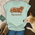 Light green t-shirt with long-haired dachshund and text "High standards."