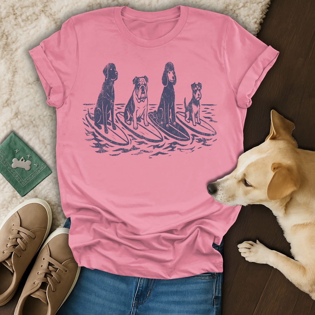 Pink t-shirt with illustration of four dogs surfing on waves.