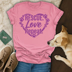 Pink t-shirt with "Rescue Love Repeat" and paw prints in heart.