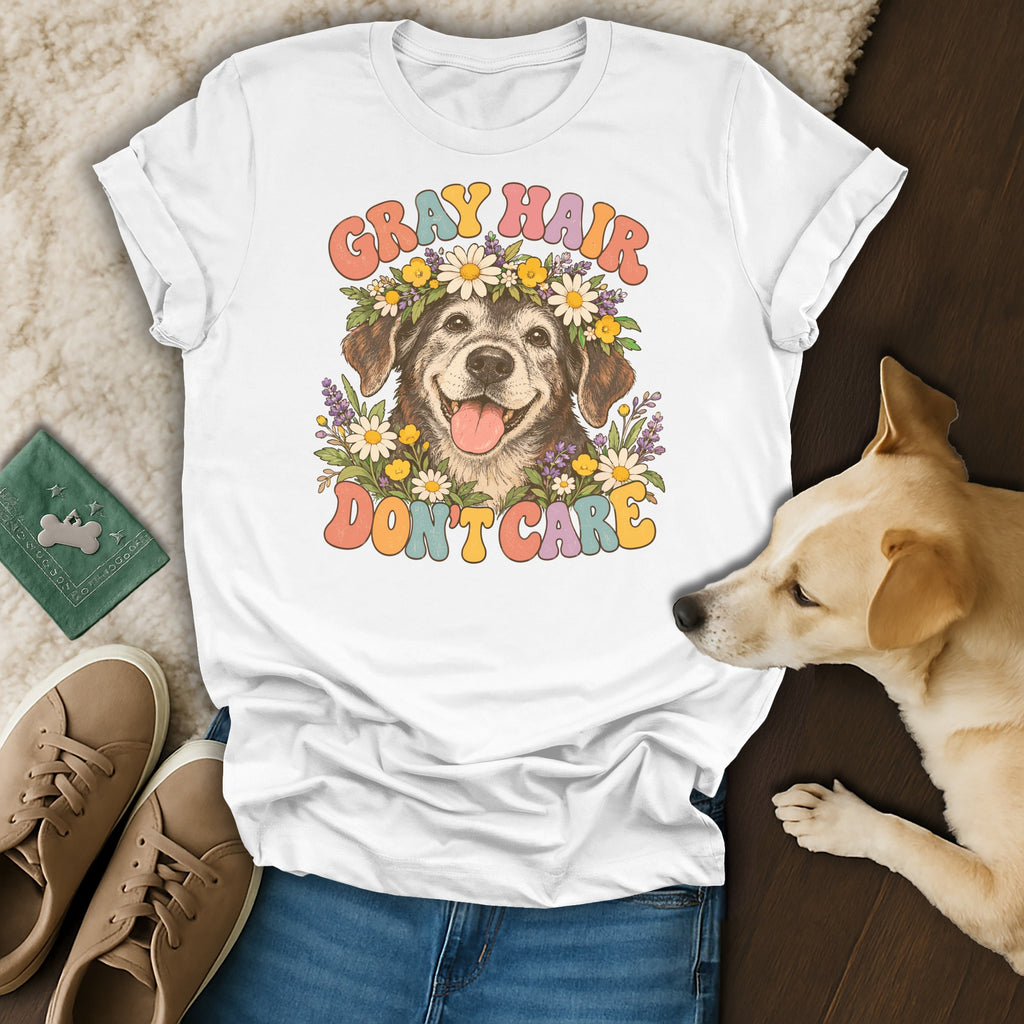 A white t-shirt featuring a retro graphic of an older dog with flowers and the text GRAY HAIR DON'T CARE.