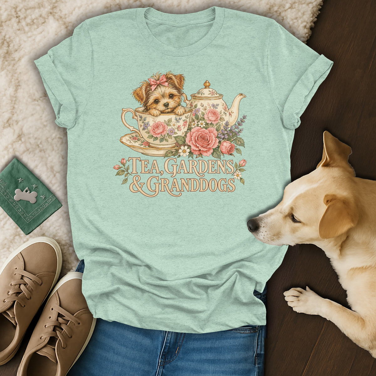 A light green t-shirt displays a vintage illustration of a puppy in a teacup with flowers and text that reads Tea, Gardens & Granddogs.