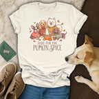 Four dogs wearing sweaters stand near pumpkins with text "Here Fur The Pupkin Spice."