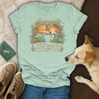 Mint green t-shirt featuring a graphic of a sleeping dog on a bench and the text Old Dogs Are The Best Dogs.