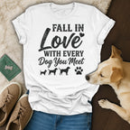 White t-shirt with "Fall in Love with Every Dog You Meet" text and dog silhouettes.