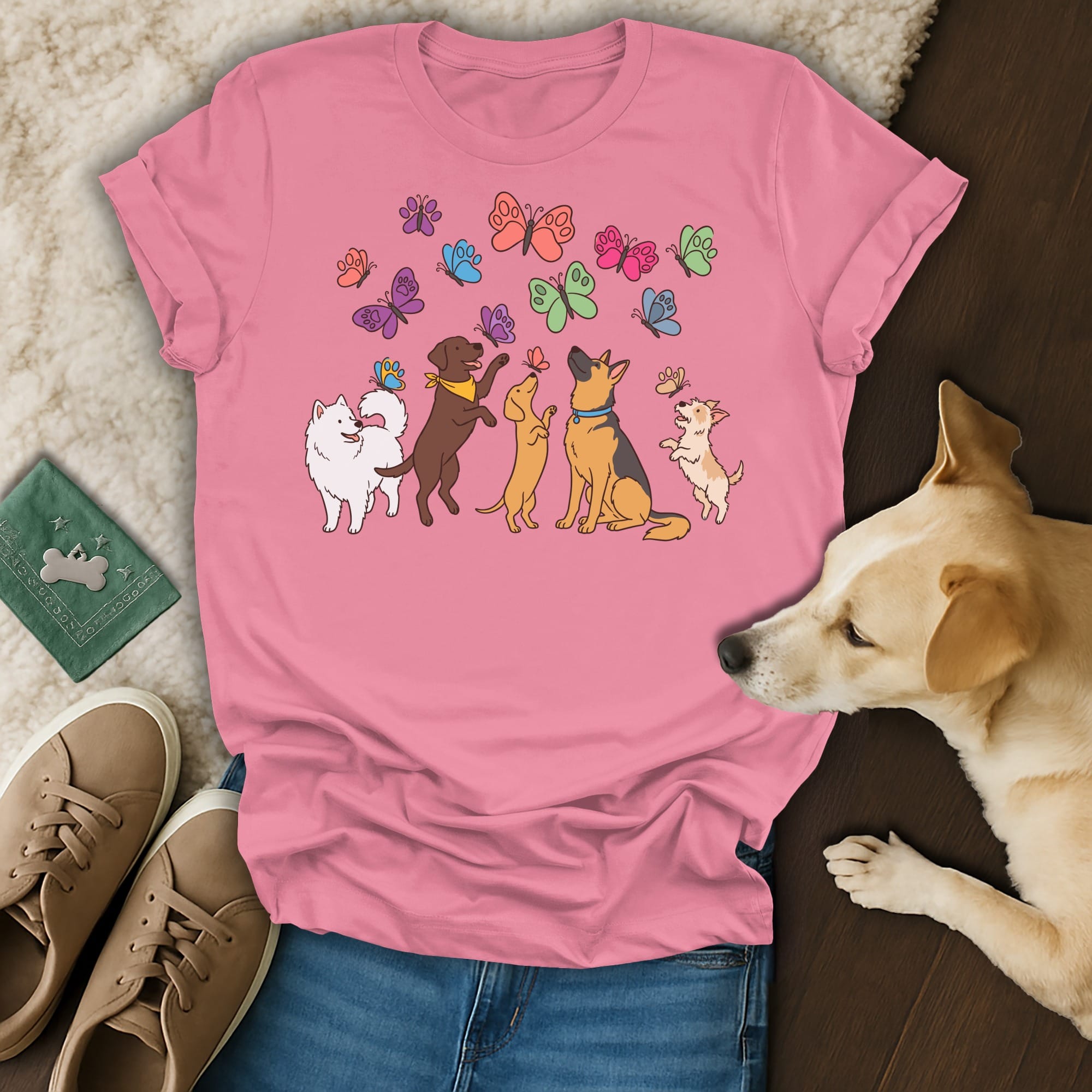 Pink t-shirt with cartoon dogs and colorful butterflies illustration.