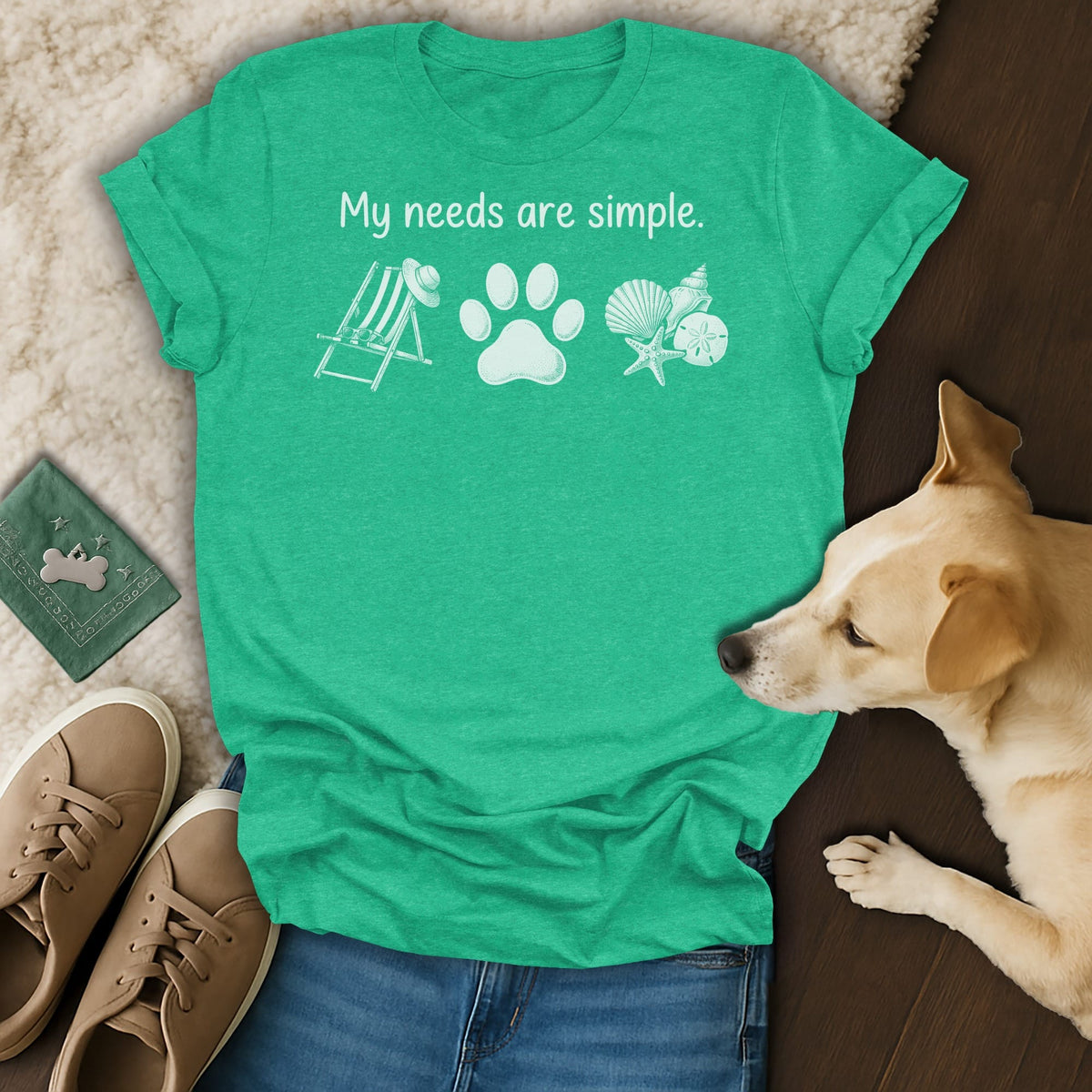 Green t-shirt with "My needs are simple" and beach and paw print graphics.