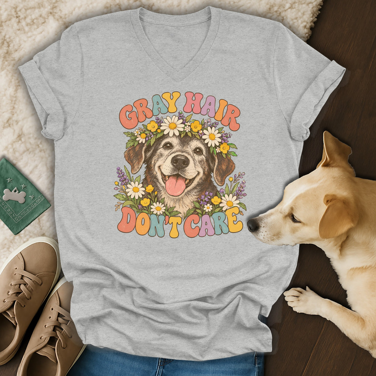 A gray V-neck t-shirt featuring a graphic of an elderly dog wearing a flower crown with the text GRAY HAIR DON'T CARE.