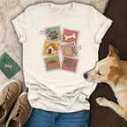 A cream crewneck t-shirt featuring a retro dog-themed stamp graphic, paired with blue jeans, sneakers, and a tan dog.