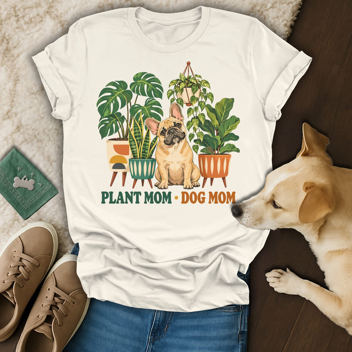 Off-white t-shirt with Plant Mom Dog Mom graphic, surrounded by shoes and a real dog.