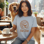 Woman with golden retriever wearing light blue t-shirt with "Fortune Favors The Dog" text.