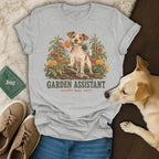 Gray t-shirt featuring a graphic of a Jack Russell terrier in a garden with text reading GARDEN ASSISTANT results may vary.