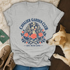 Heather gray V-neck t-shirt featuring a Cavalier King Charles Spaniel graphic with flowers and gardening tools.