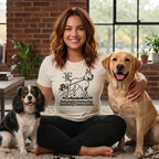 Woman sitting with a Cavalier King Charles Spaniel and a Labrador Retriever.