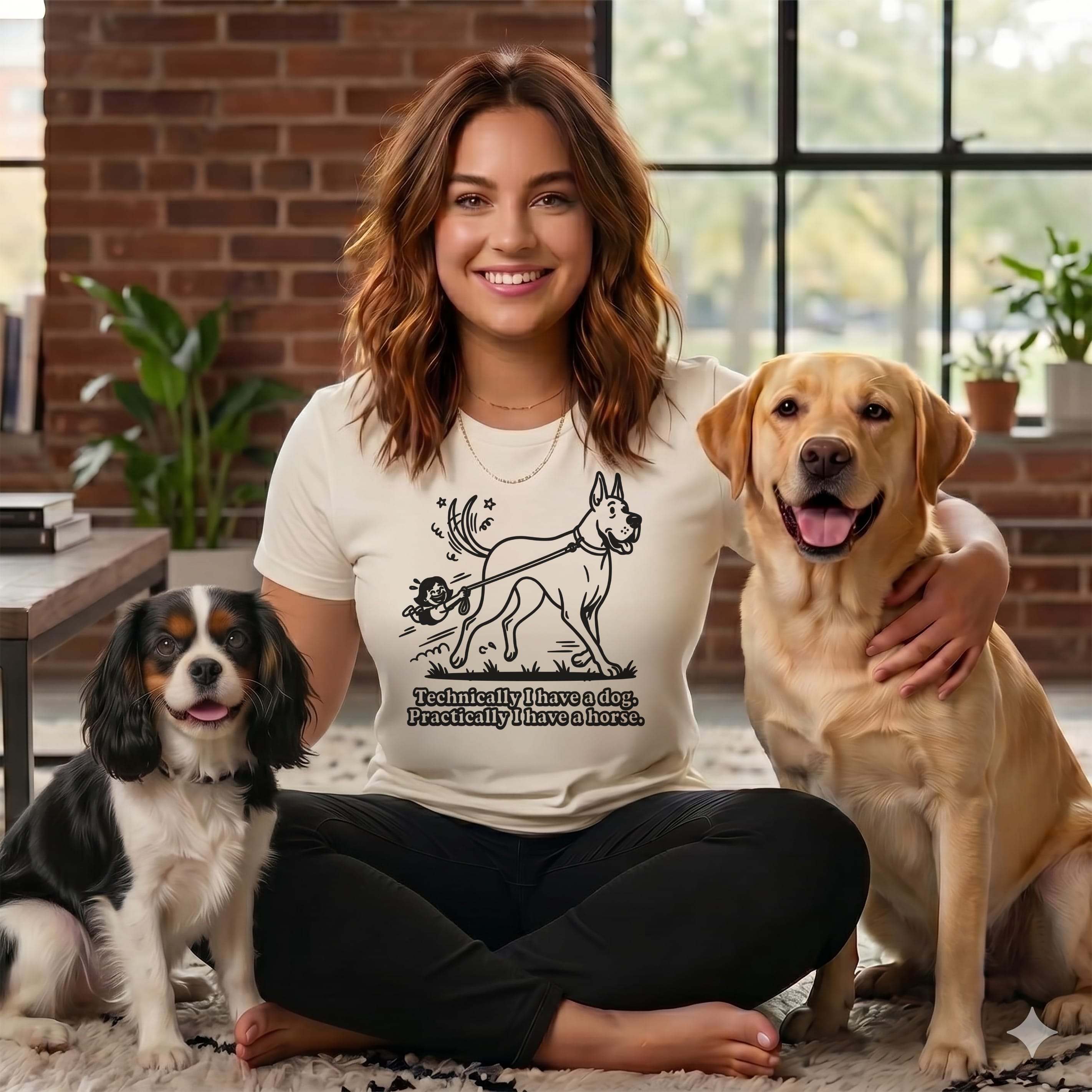 Woman sitting with a Cavalier King Charles Spaniel and a Labrador Retriever.