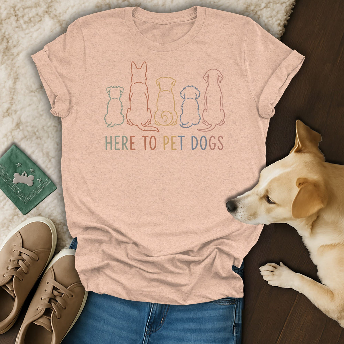 Peach t-shirt with line drawings of five dogs and the text HERE TO PET DOGS.