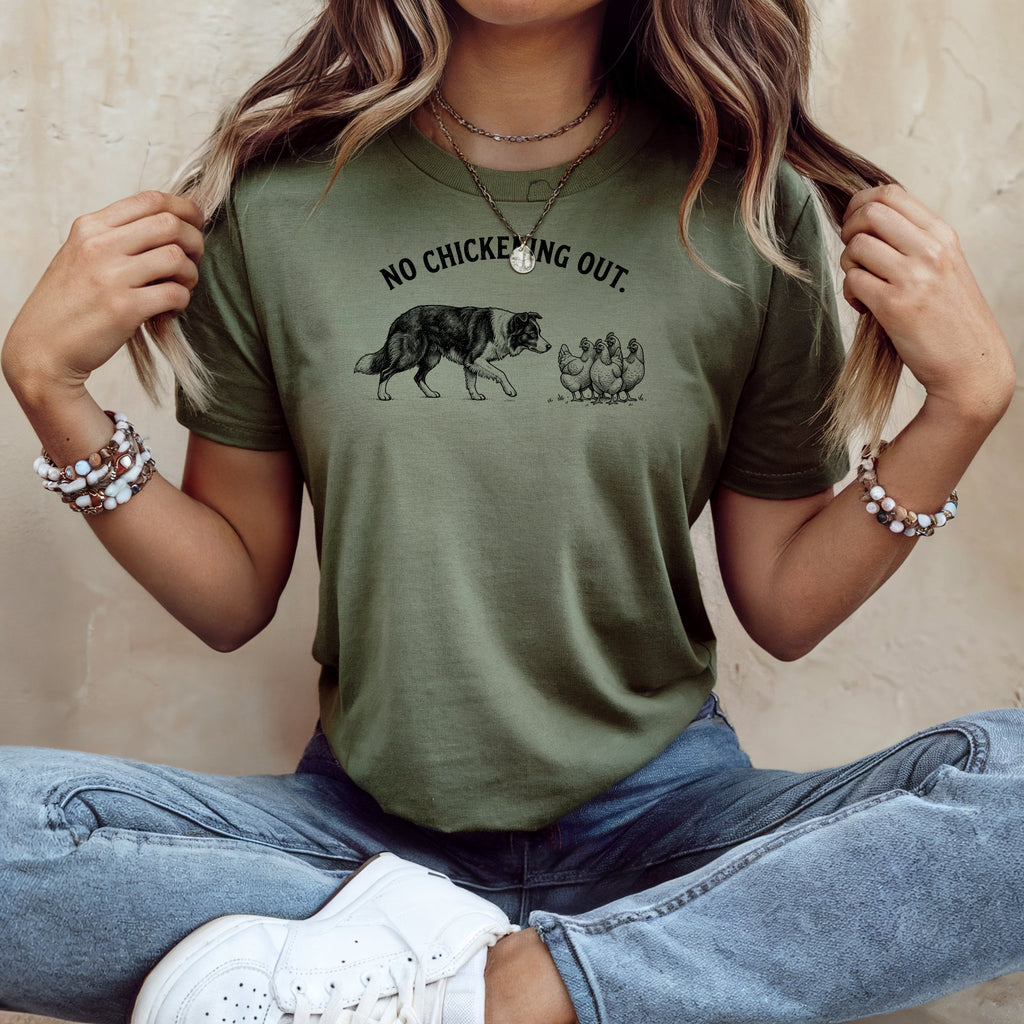 Green t-shirt with black graphic of a dog and chickens, text "NO CHICKENING OUT."