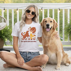 Woman and golden retriever on a porch wearing a t-shirt with "Free spirits find each other" text.