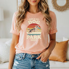 Peach t-shirt with vintage graphic of dog catching frisbee, "This is my Dog Park shirt."