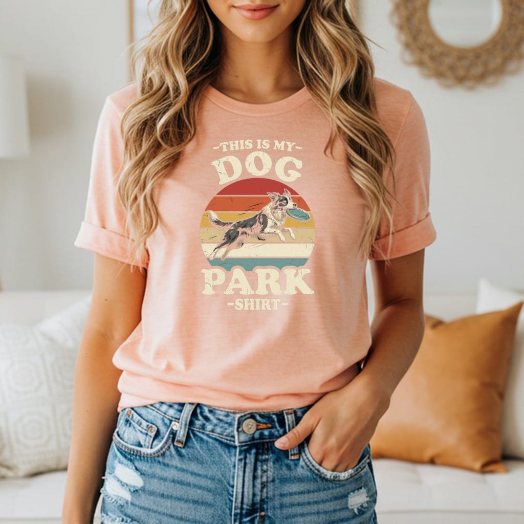 Peach t-shirt with vintage graphic of dog catching frisbee, "This is my Dog Park shirt."