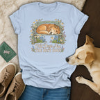 Light blue t-shirt with a vintage illustration of a sleeping dog on a bench and text reading Old Dogs Are The Best Dogs.