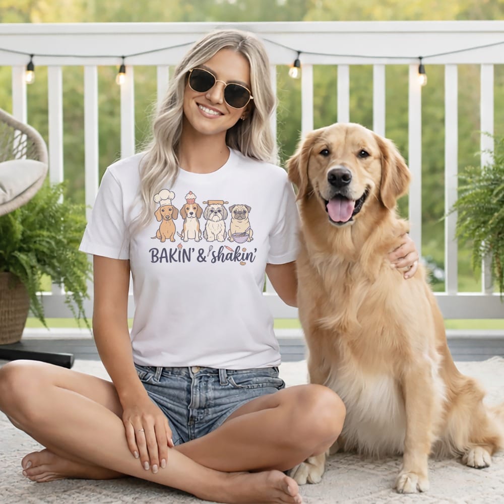 White t-shirt with cartoon dogs wearing chef hats and the text "Bakin' & shakin'".