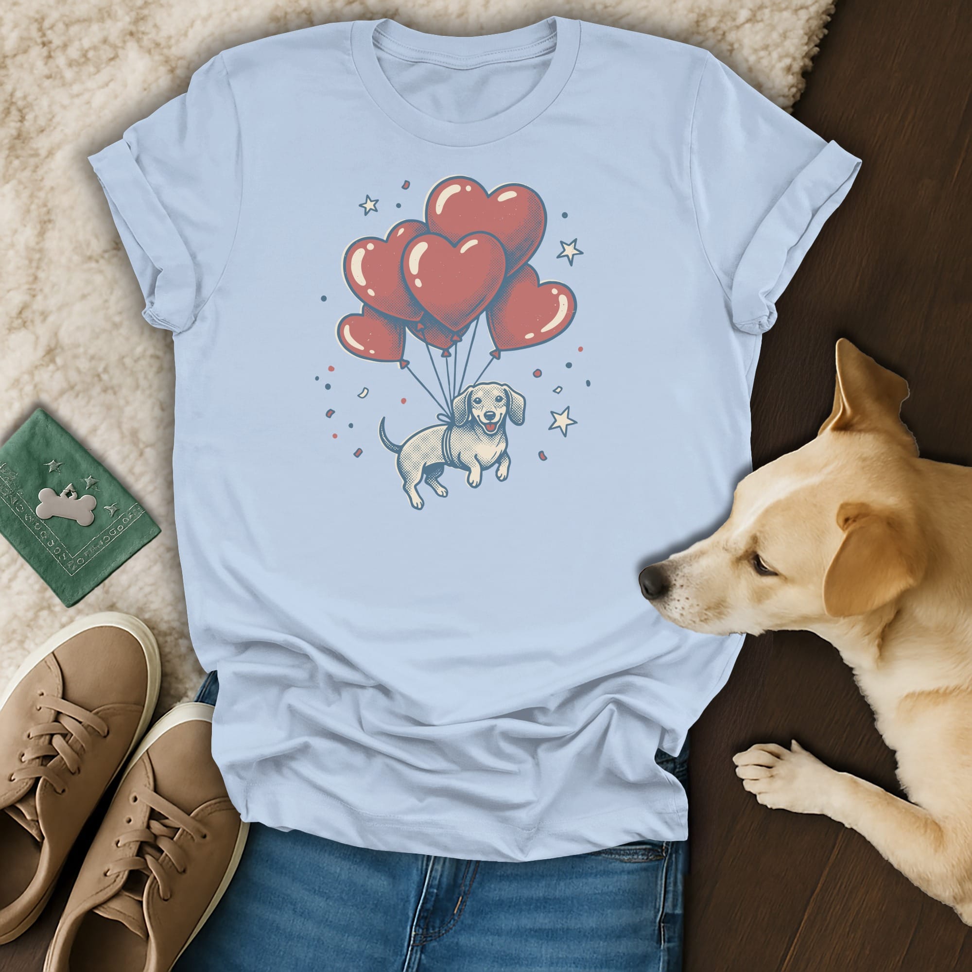 Light blue t-shirt with a graphic of a dachshund floating with heart balloons.