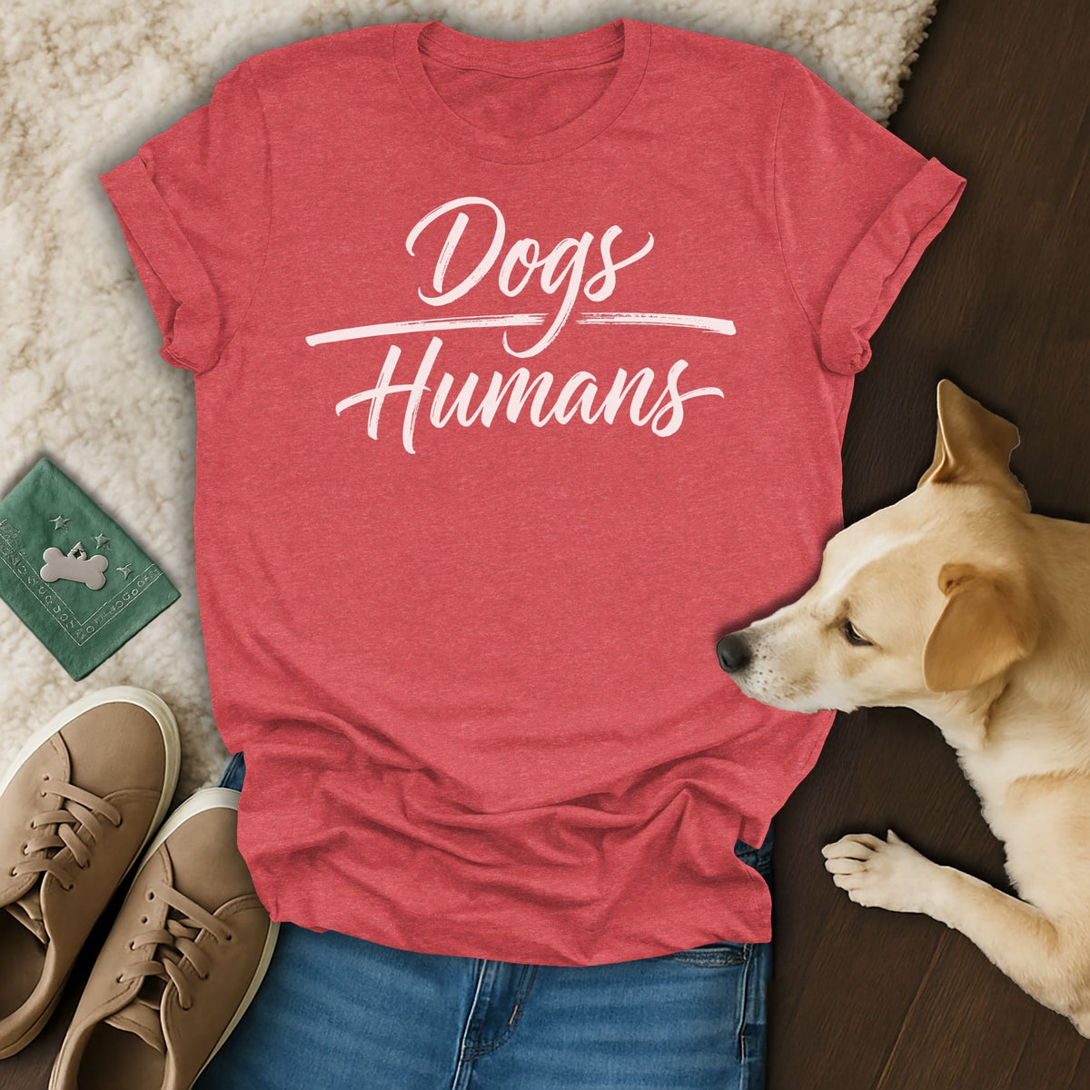 Red t-shirt with white text "Dogs Humans", dog, jeans, and sneakers.